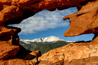 Snow Covered Pikes Peak Seen through the Opening in Siamese Twins Rocks in Garden of the Gods